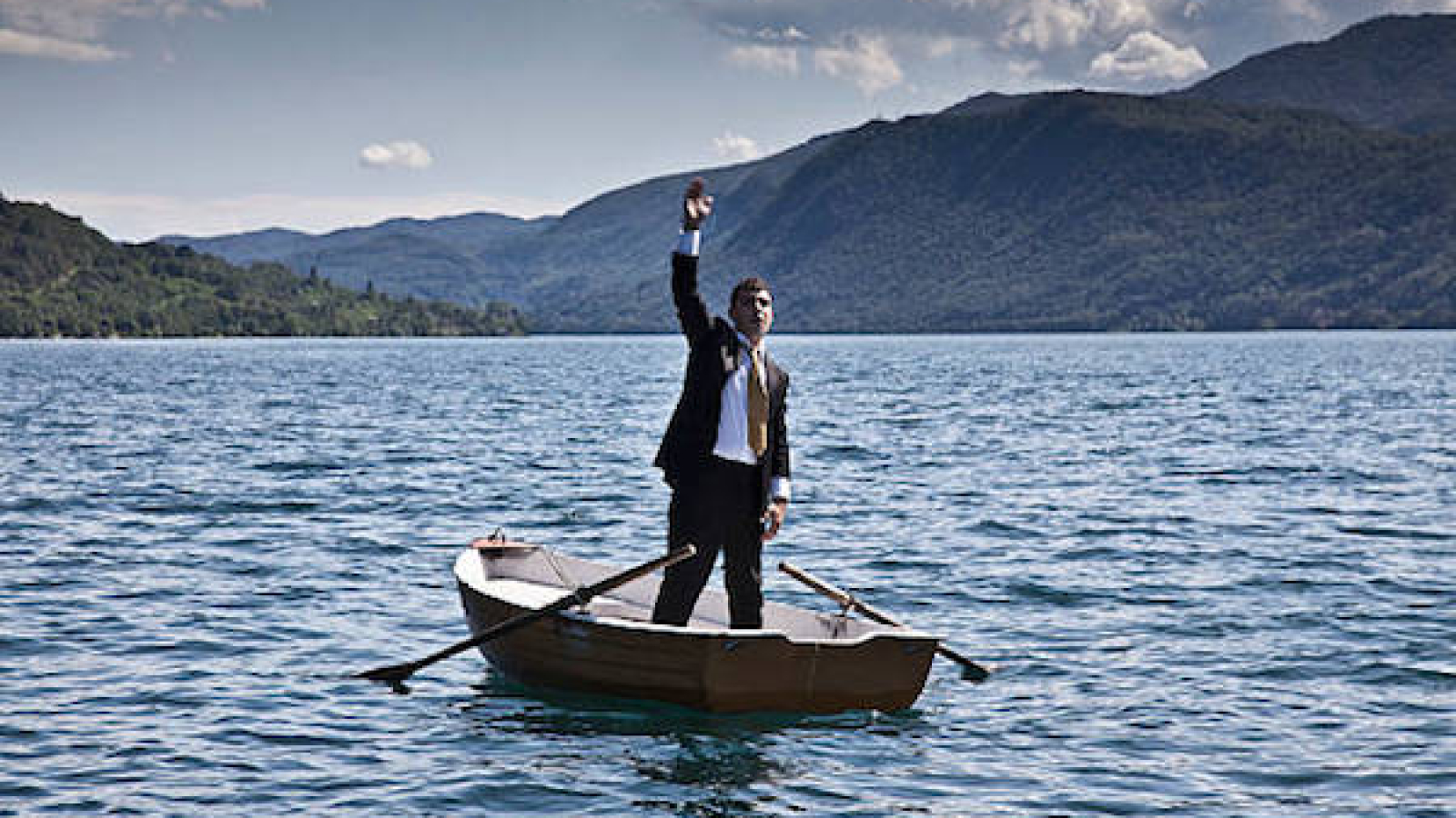 Businessman calling for help in rowboat